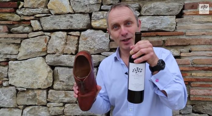 Open bottle of wine with shoe