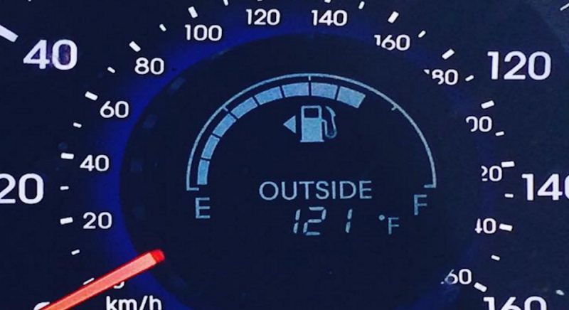 A dashboard showing the Palm Springs weather is hot outside
