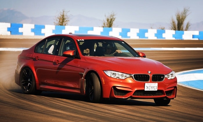 A vehicle speeds around the BMW Performance Center Driving School - where you can save up to 50% off with these coupons and codes